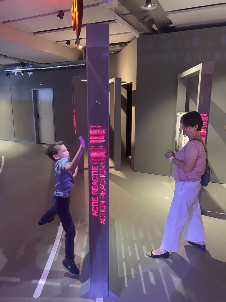 Miaomiao and Max with the Action Reaction game at the Humania Exhibition at the Fourth Floor of the NEMO Science Museum, with explanation