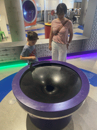 Miaomiao and Max with a spiral wishing well at the Fenomena exhibition at the First Floor of the NEMO Science Museum