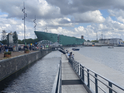 The pier at the Oosterdokskade street, the Mr. J.J. van der Veldebrug bridge over the Oosterdok canal and the the NEMO Science Museum