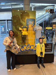Miaomiao and Max in front of Pokémon items at the shop at the lower ground floor of the entrance building of the Van Gogh Museum