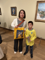 Miaomiao and Max with the painting `Self-Portrait with Grey Felt Hat` by Vincent van Gogh at the second floor of the Van Gogh Museum