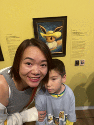 Miaomiao and Max with the painting `Eevee inspired by Self-Portrait with Straw Hat` by Sowsow at the `Pokémon at the Van Gogh Museum` exhibition at the second floor of the Van Gogh Museum, with explanation
