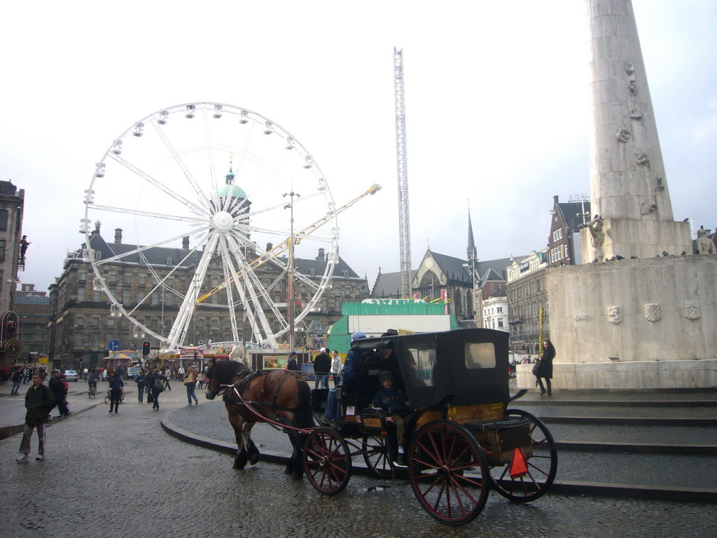 The Dam square, with the Nationaal Monument, the Royal Palace Amsterdam, the Nieuwe Kerk church, a Ferris Wheel and a Horse Tram