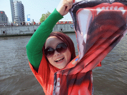 Miaomiao with orange lion shirt on the tour boat at the IJ river