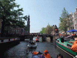 Jola, Irene, Mengjin and others on the tour boat at the Prinsengracht canal, with the bridge at the crossing of the Leliegracht canal and the tower of the Westerkerk church
