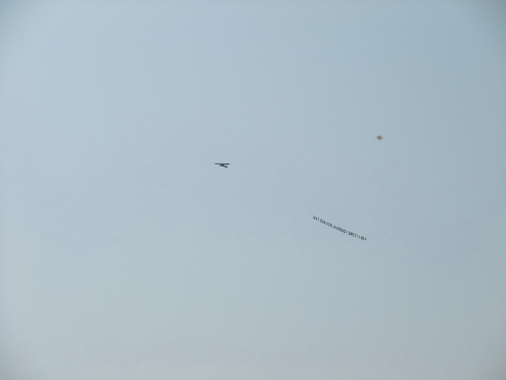 Airplane flying with a message banner over the city center