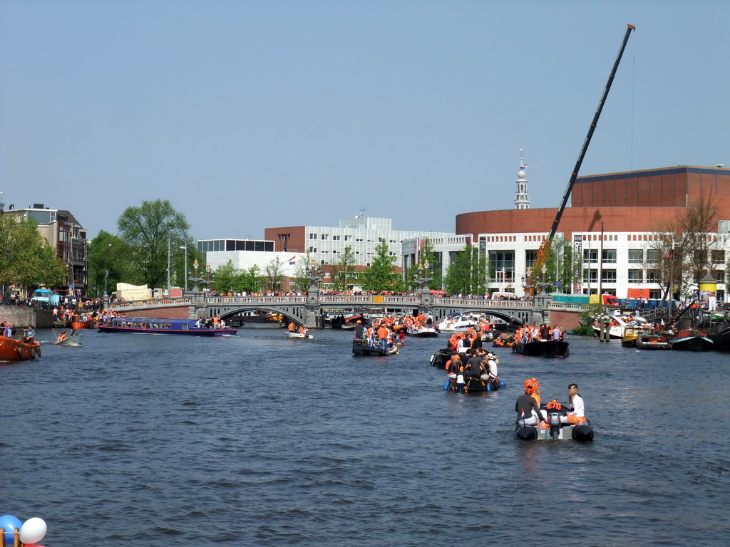 The Amstel river with the Blauwbrug bridge, the Stopera and the tower of the Zuiderkerk church