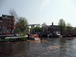 The Amstel river, the bridge at the crossing of the Nieuwe Herengracht canal and the Hermitage Amsterdam museum