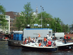 Tour boats at the Amstel river, and the tower of the Zuiderkerk church