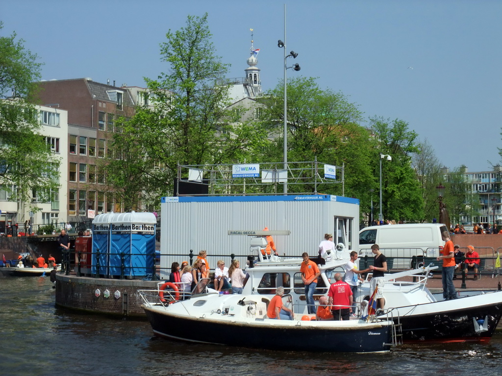 Tour boats at the Amstel river, and the tower of the Zuiderkerk church