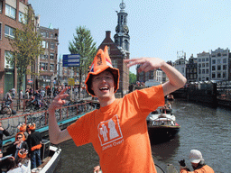 David on the tour boat at the Singel canal with the Munttoren tower at the Muntplein square