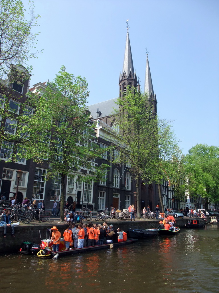 Houses and tour boats at the Singel canal and the Krijtberg church