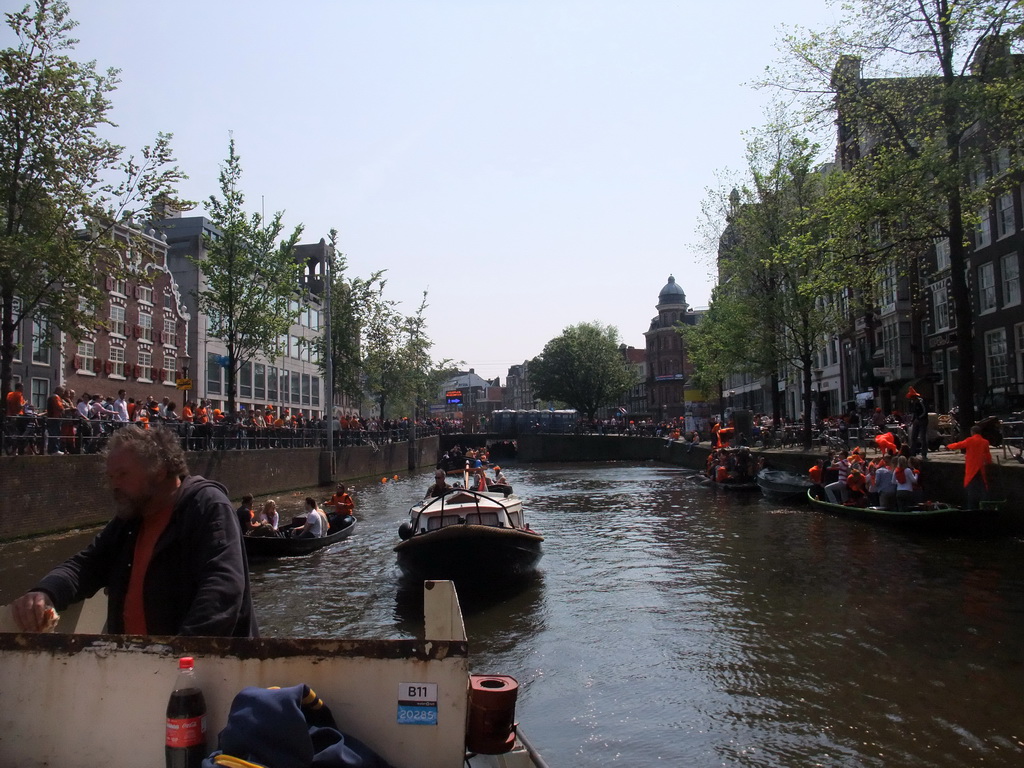 The skipper on the tour boat at the Singel canal with the Koningsplein square