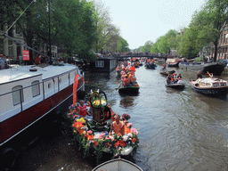 Flower boat at the Singel canal with the bridge at the crossing of the Korte Korsjespoortsteeg street