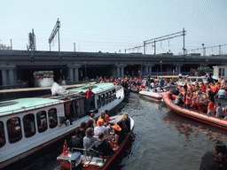 Tour boats at the Westerdok canal with the railway crossing