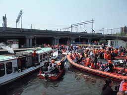 Tour boats at the Westerdok canal with the railway crossing