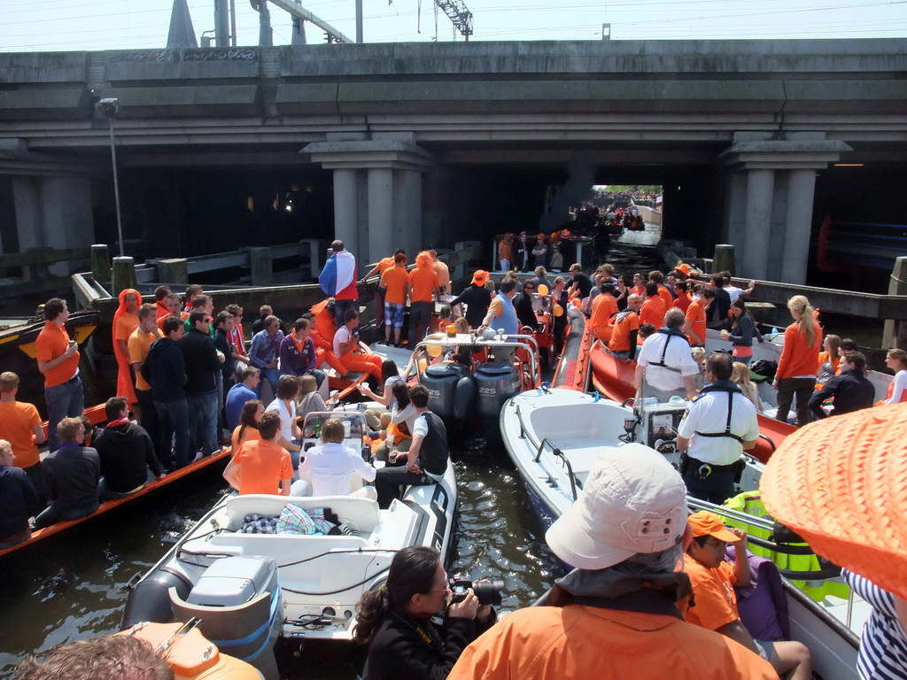 Tour boats at the Westerdok canal with the railway crossing