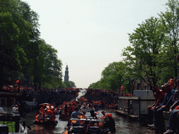 Tour boats at the Korte Prinsengracht canal, with the bridge at the crossing of the Brouwersgracht canal and the tower of the Westerkerk church