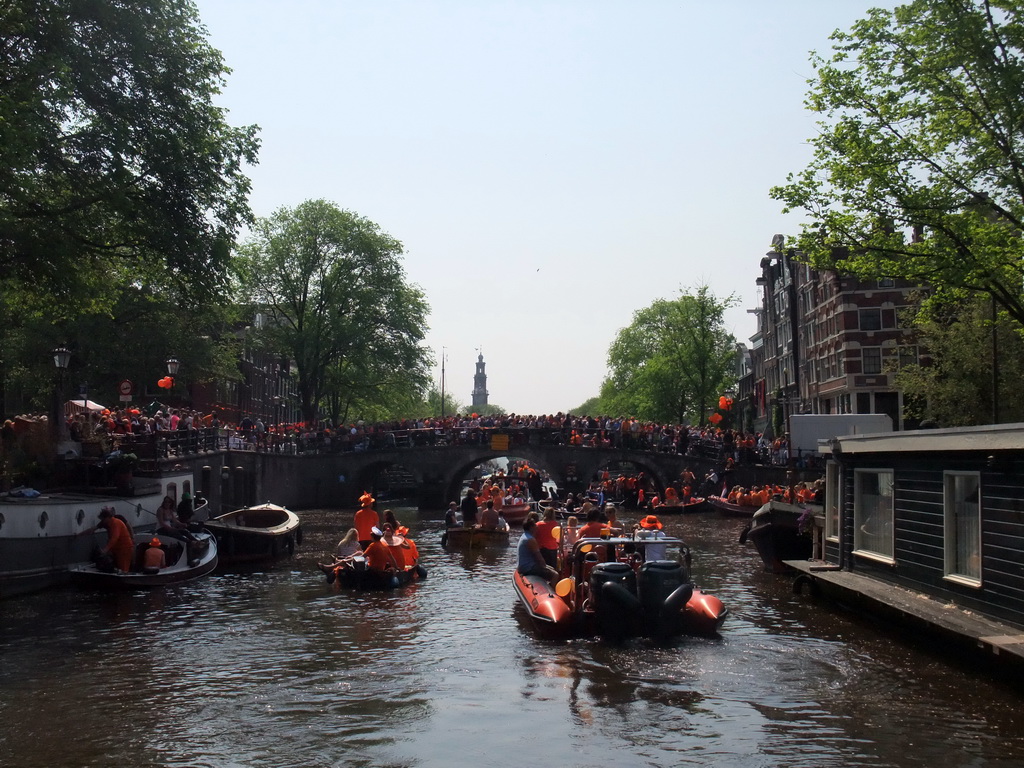 Tour boats at the Korte Prinsengracht canal, with the bridge at the crossing of the Brouwersgracht canal and the tower of the Westerkerk church