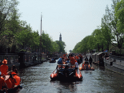 Tour boats at the Prinsengracht canal, with the tower of the Westerkerk church