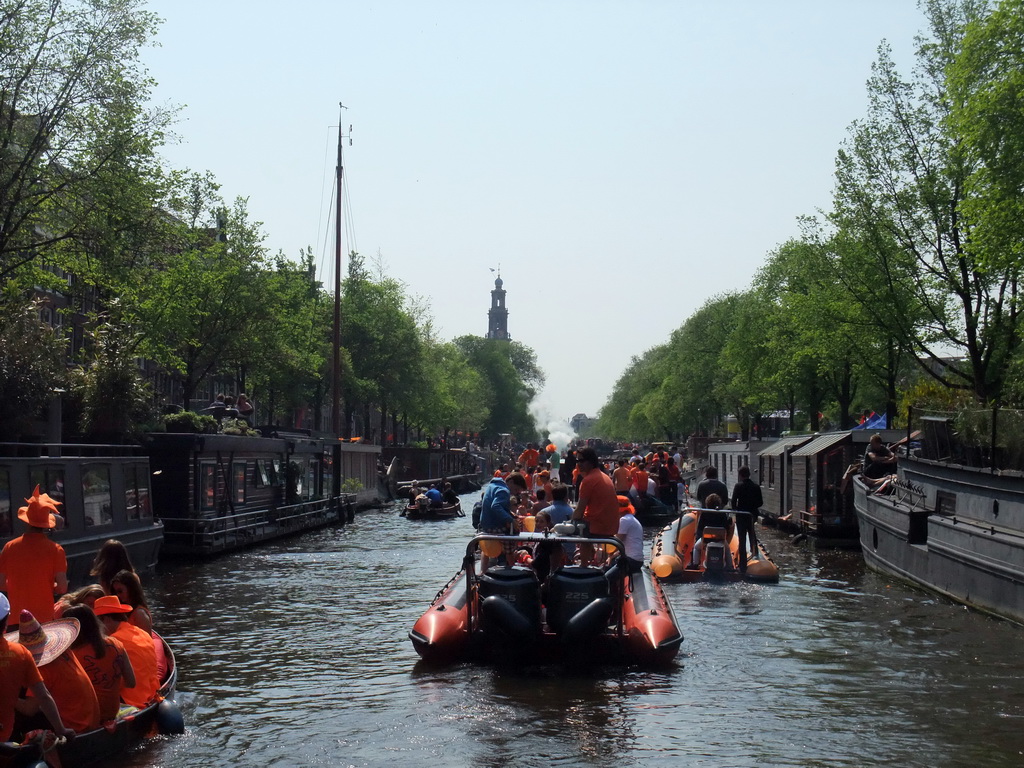 Tour boats at the Prinsengracht canal, with the tower of the Westerkerk church