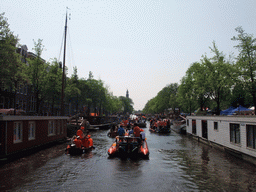 Tour boats at the Prinsengracht canal, with the tower of the Westerkerk church