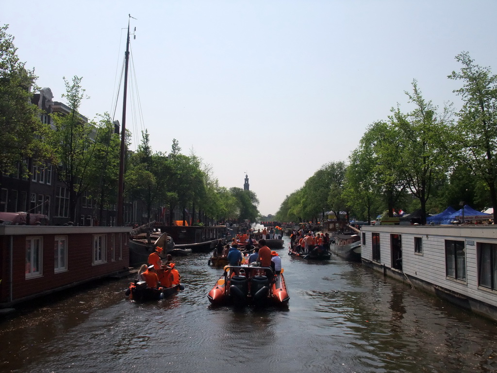 Tour boats at the Prinsengracht canal, with the tower of the Westerkerk church