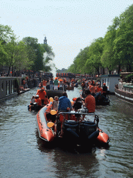 Tour boats at the Prinsengracht canal, with the bridge at the crossing of the Prinsenstraat street and the tower of the Westerkerk church