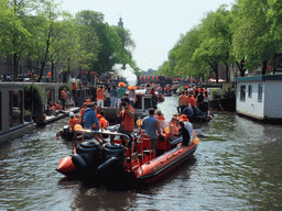 Tour boats at the Prinsengracht canal, with the bridge at the crossing of the Prinsenstraat street and the tower of the Westerkerk church