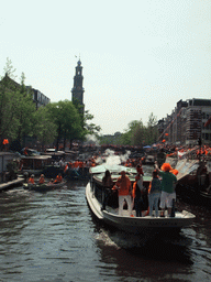 Tour boats at the Prinsengracht canal, with the bridge at the crossing of the Leliegracht canal and the tower of the Westerkerk church