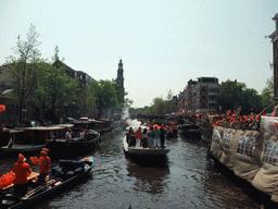 Tour boats at the Prinsengracht canal, with the bridge at the crossing of the Leliegracht canal and the tower of the Westerkerk church