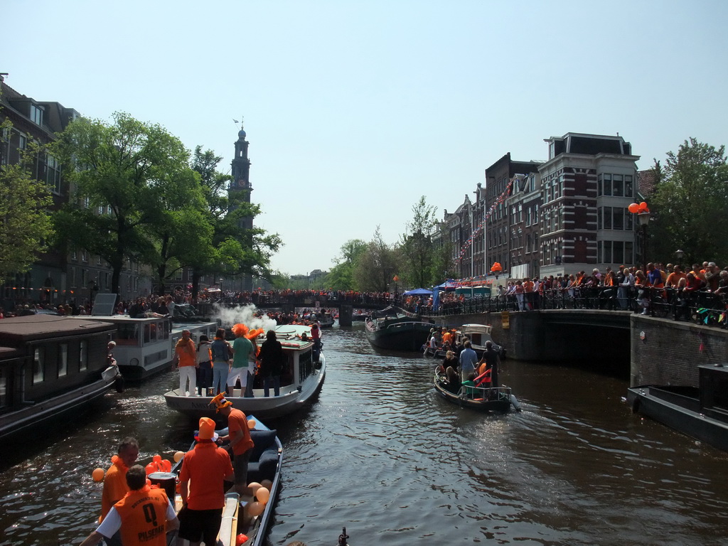 Tour boats at the Prinsengracht canal, with the bridges at the crossings of the Egelantiersgracht and Leliegracht canals and the tower of the Westerkerk church