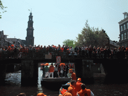 Tour boats at the Prinsengracht canal, with the bridge at the crossing of the Leliegracht canal and the tower of the Westerkerk church