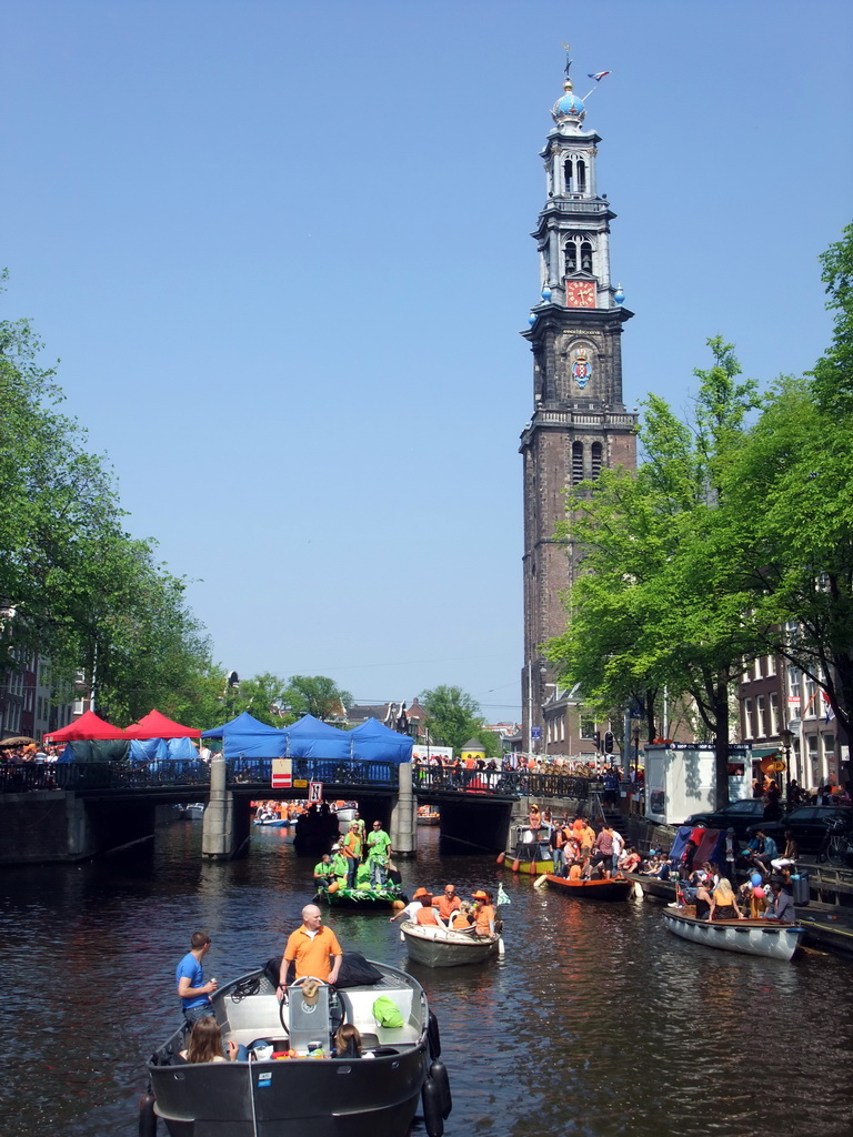 Tour boats at the Prinsengracht canal, with the bridge at the crossing of the Westermarkt square, and the Westerkerk church