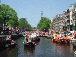 Tour boats at the Prinsengracht canal, with the bridge at the crossing of the Reestraat street, and the tower of the Westerkerk church