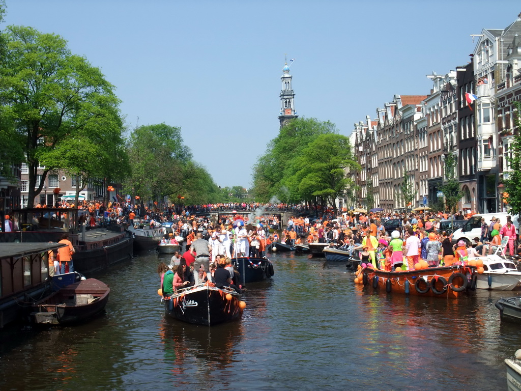 Tour boats at the Prinsengracht canal, with the bridge at the crossing of the Reestraat street, and the tower of the Westerkerk church