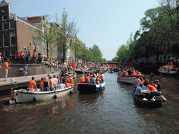 Tour boats at the Prinsengracht canal, with the bridge at the crossing of the Leidsestraat street