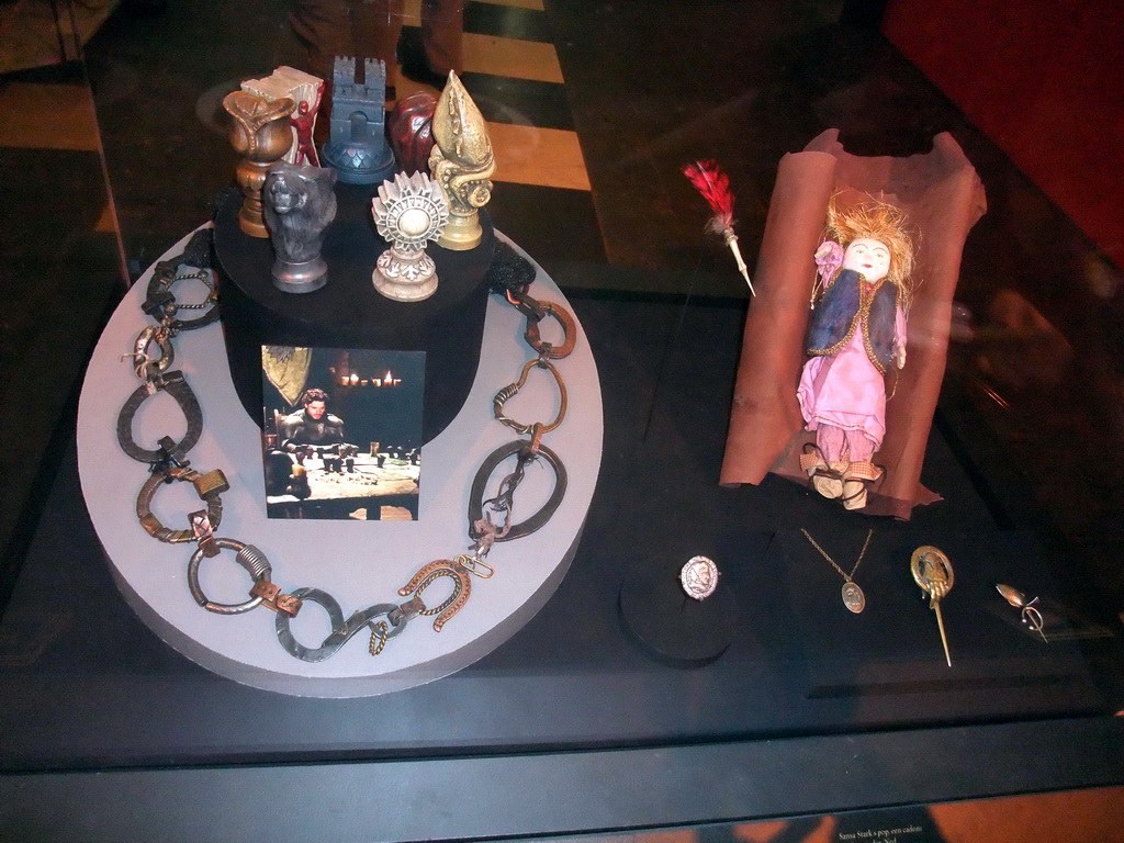 Statuettes of the Houses of Westeros, horseshoes, a photograph of Robb Stark, doll and pins at `Game of Thrones: the Exhibition` at the Posthoornkerk church