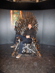 Tim sitting on the Iron Throne at `Game of Thrones: the Exhibition` at the Posthoornkerk church