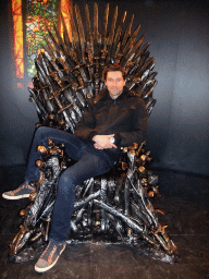 Tim sitting on the Iron Throne at `Game of Thrones: the Exhibition` at the Posthoornkerk church