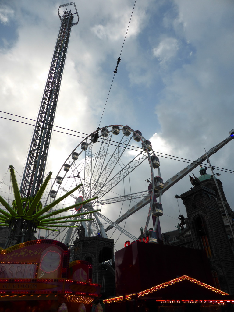 Ferris Wheel, other funfair attractions and the Royal Palace Amsterdam palace at the Dam square