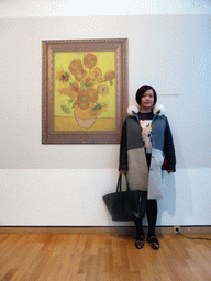 Miaomiao with a poster of the temporarily removed painting `Sunflowers` by Vincent van Gogh at the Van Gogh Museum