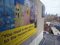 View on the Museumplein square with the Rijksmuseum and a poster on the Van Gogh Museum, viewed from the south side of the main building of the Van Gogh Museum