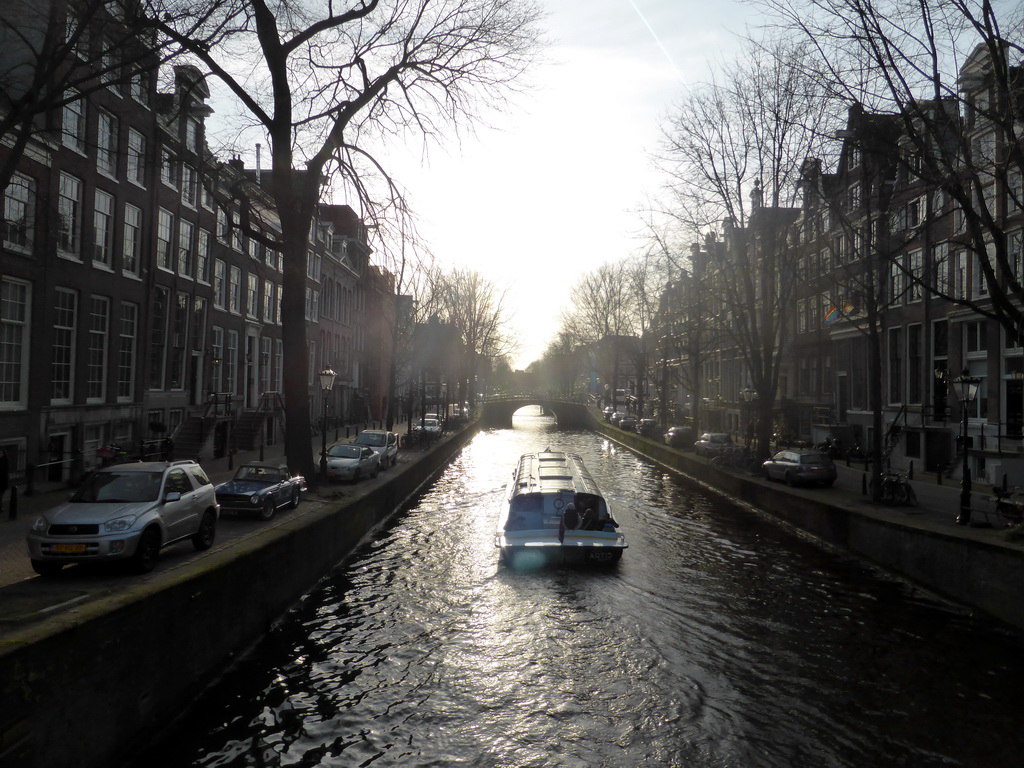Boat in the Leidsegracht canal, viewed from a bridge at the Herengracht canal
