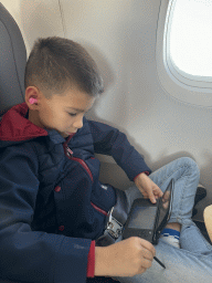 Max playing on his Nintendo 3DS XL in the airplane from Antwerp