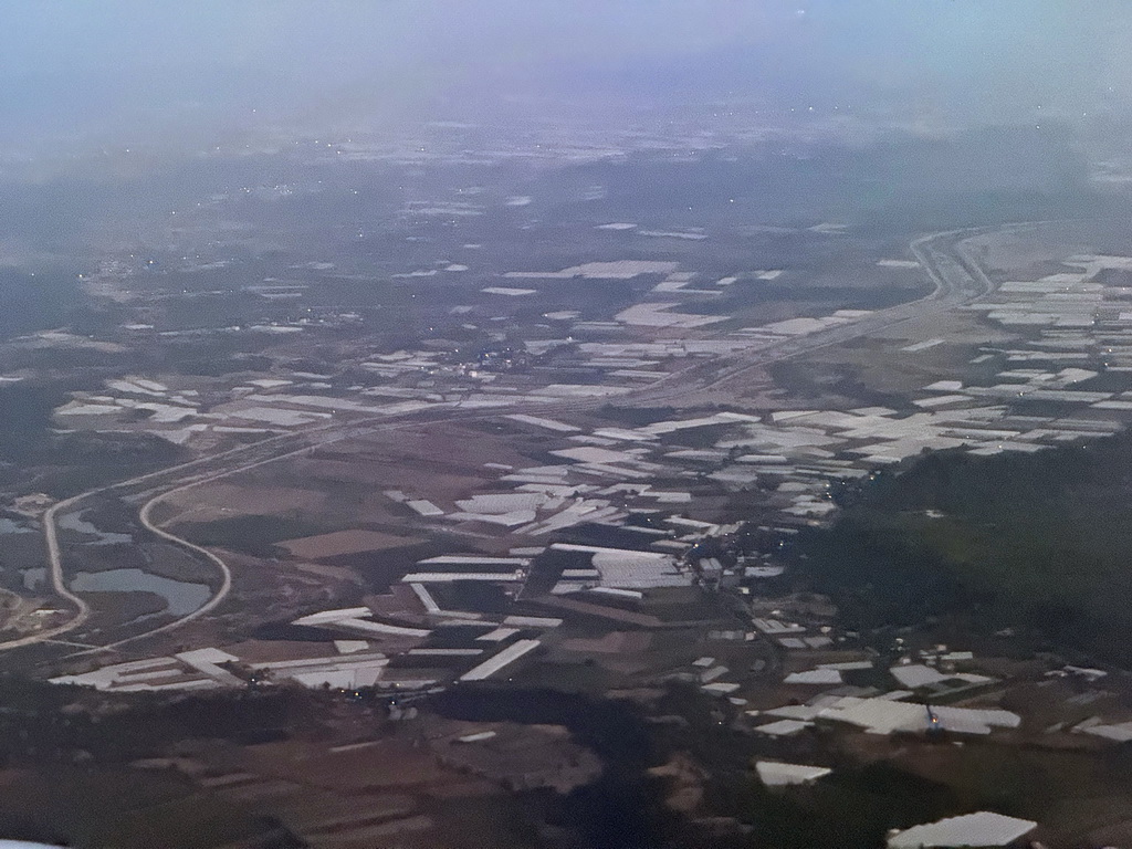 The Aksu Stream and greenhouses at the northeast side of the city, viewed from the airplane from Antwerp, at sunset