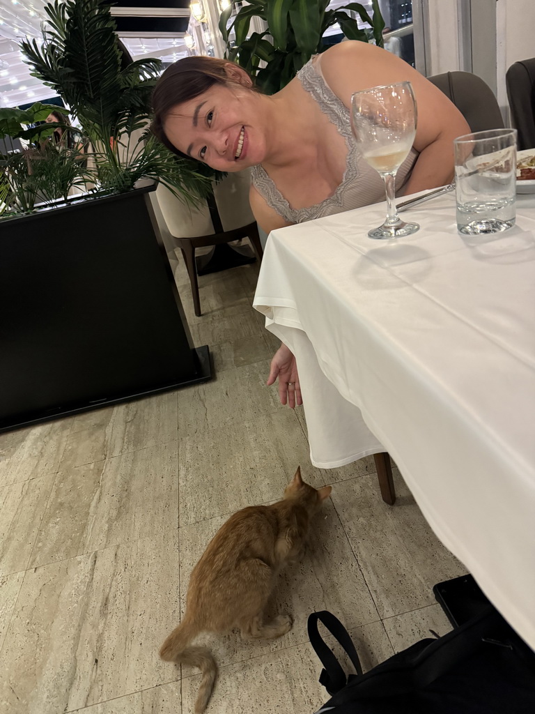 Miaomiao with a cat at the Panoramic Restaurant at the Rixos Downtown Antalya hotel