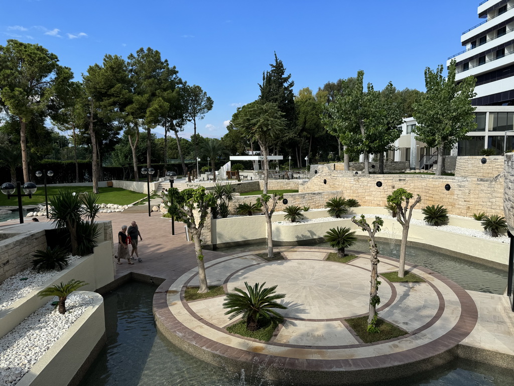 Pond with fountains and the terrace of the Turunc restaurant at the garden of the Rixos Downtown Antalya hotel