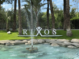 Pond with fountain and sign at the garden of the Rixos Downtown Antalya hotel
