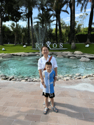 Miaomiao and Max in front of a pond with fountain and sign at the garden of the Rixos Downtown Antalya hotel